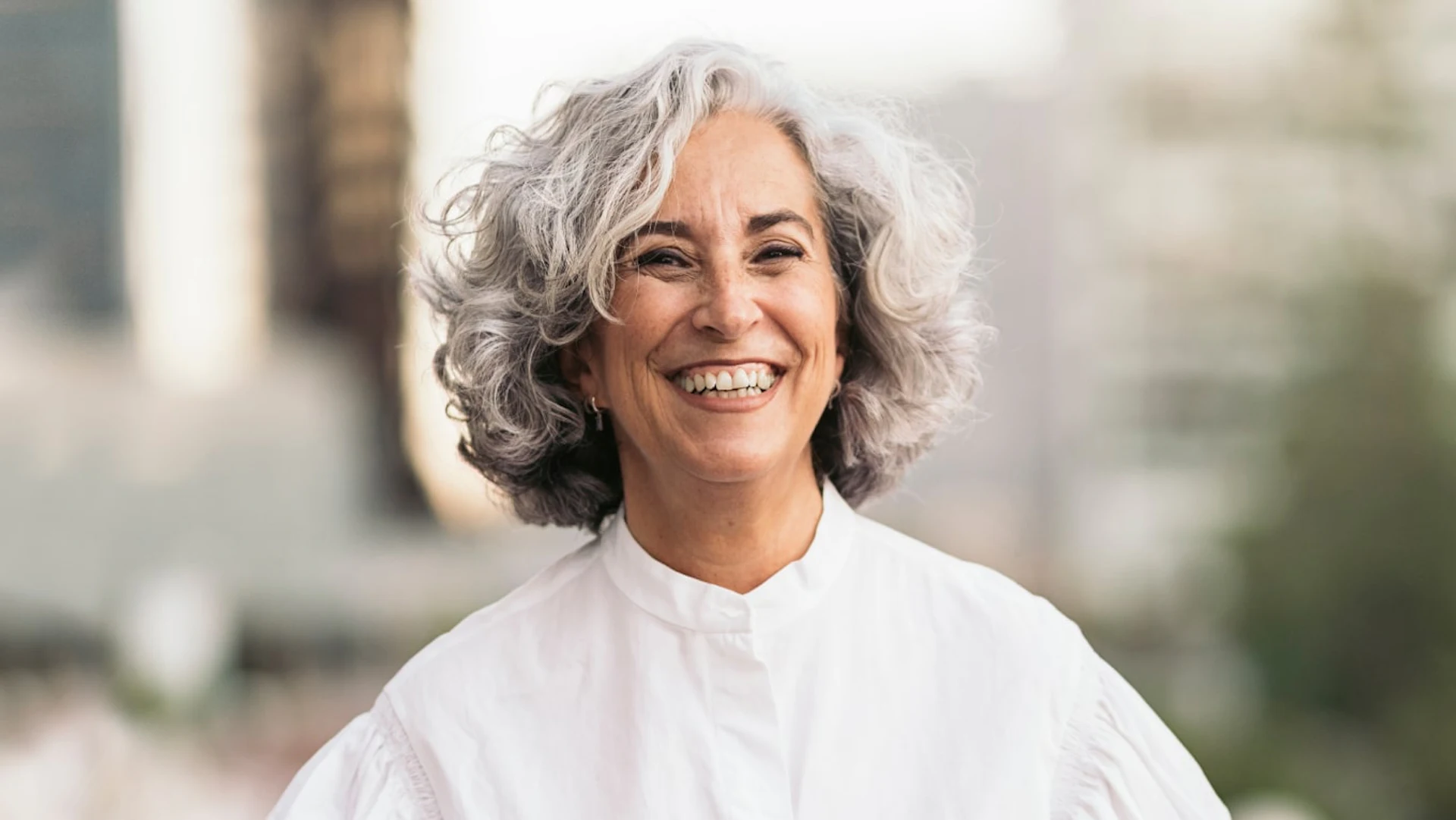 Smiling mature woman with gray curly hair